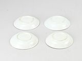 four white cups and saucers sitting on top of a white table