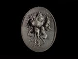 a close up of a silver medallion with a dragon on it