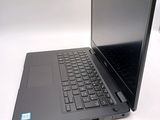 a laptop that is open on a white table