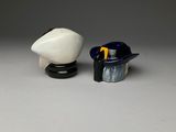 two figurines of a man and a woman sitting next to each other