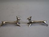 pair of silver deer earrings on a white surface