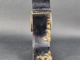 a silver and gold clock that is on a table