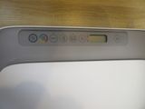 a close up of a remote control on a wooden table