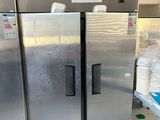 three stainless steel refrigerators in a room with a lot of boxes
