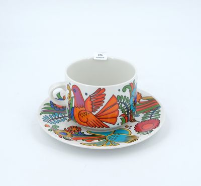 a cup and saucer with a bird design on it