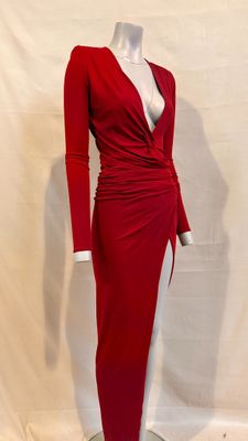 the red dress is on display on a mannequin stand