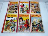 four vintage children ' s comic books are on display on a table