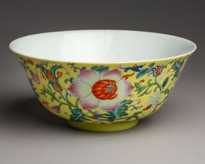 yellow and pink bowl with flowers and vines on a grey background