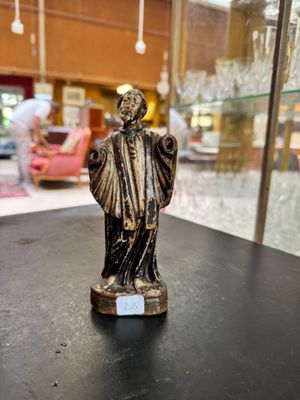 a statue of a man that is on a table