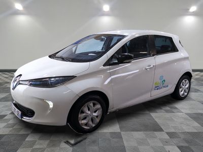 a picture of a small white car parked in a garage