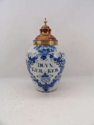 an image of a blue and white vase with a gold lid