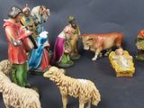 many figurines of people and animals on a table