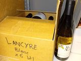 a box of wine and a bottle of wine on a counter