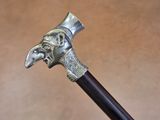 a close up of a walking stick with a bird head on it