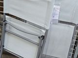 two folding chairs sitting on the side of the street