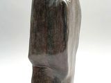 a close up of a sculpture of a face on a white surface