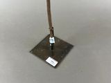 an image of a metal pole with a stick sticking out of it