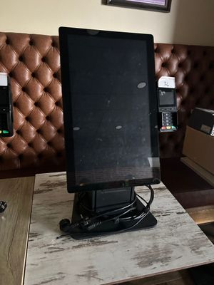 a computer monitor sitting on top of a wooden table
