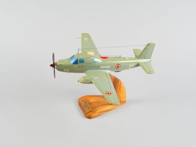un petit avion en jouet posé sur un socle en bois