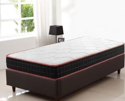 a bed that has a mattress on it in a room