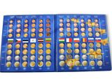 blue box of coins with different countries on it