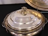 a silver plate with a glass lid on a table