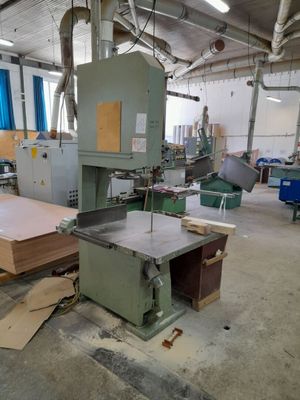a machine that is working on a piece of wood in a factory