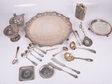 a lot of silverware on a white table