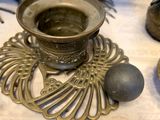 a silver cup sitting on top of a table next to a metal object