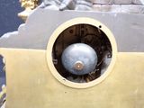 a clock that has a silver ball in the middle of it