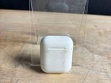 clear plastic box with a small white object in it on a wooden table