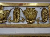 a picture of a wall with gold decorations on it