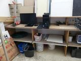 a desk with a computer on it in a room