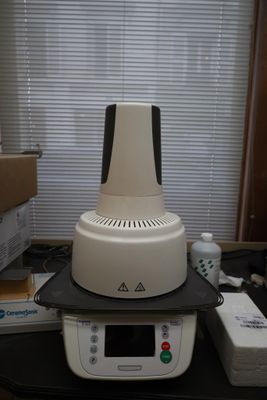 a white and black machine sitting on top of a desk