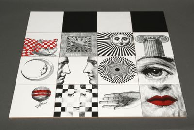 a black and white picture of a woman ' s face on a tile