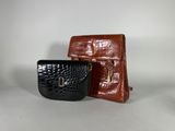 two small purses are sitting next to each other on a table