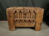 an old wooden chest with a shelf on top of it