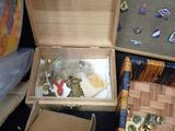 a wooden box filled with assorted items sitting on the floor