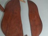 two pieces of wood sitting on top of a table