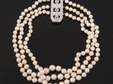 a three strand pearl necklace with a clasp
