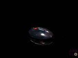 a computer mouse sitting on top of a black surface