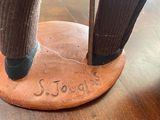 a statue of a person standing on top of a wooden table