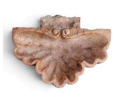 a stone sculpture of a bird on a white surface