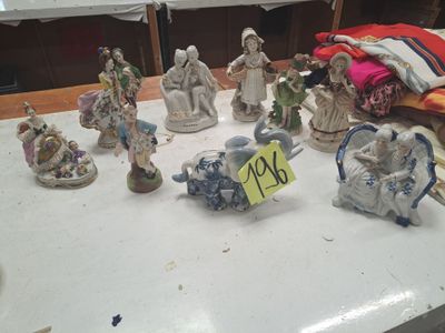 many figurines that are on a table with a price tag
