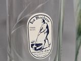 a glass vase with a sticker on it sitting on a table