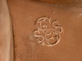 a close up of a vase with a flower design on it