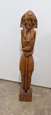 wooden statue of an egyptian woman holding a baby in her arms
