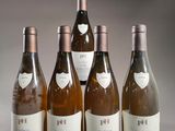 six bottles of wine are lined up in a row on a table
