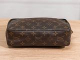 louis vuittou toilet bag on a wooden table