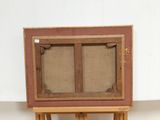 a small wooden easel with a painting on top of it